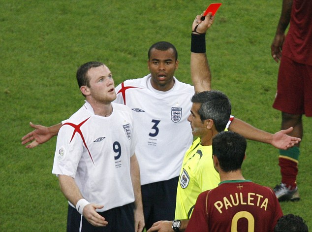 Referee Horacio Elizondo of Argentina shows England's Wayne Rooney (L) a red card as Ashley Cole (C) watches during their World Cup 2006 quarter-final soccer match against Portugal in Gelsenkirchen July 1, 2006. FIFA RESTRICTION - NO MOBILE USE REUTERS/Shaun Best (GERMANY)