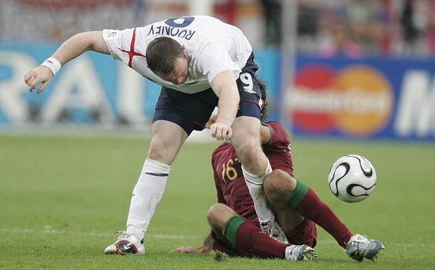 ENGLAND V PORTUGAL. GELSENKIRCHEN. GERMANY. PIC ANDY HOOPER wayne rooney stamps on CARVALHO