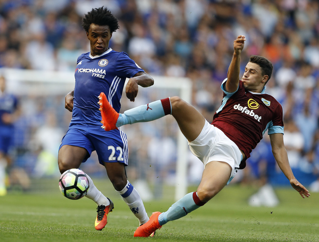 Chelsea's Willian, left, and Burnley's Matthew Lowton challenge for the ball.