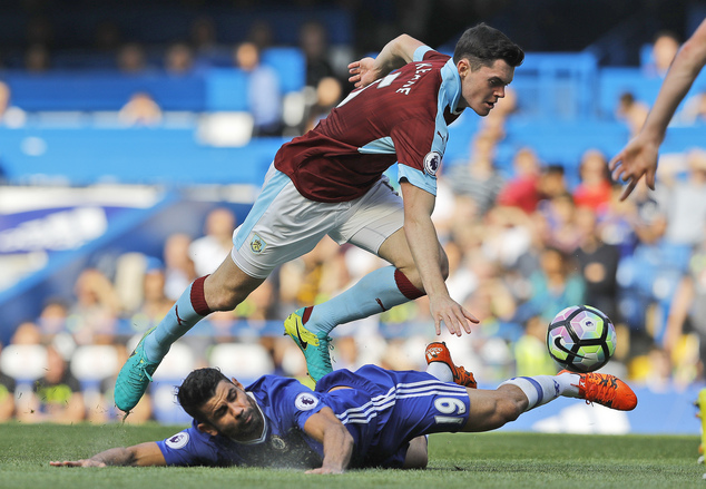 Chelsea's Diego Costa, bottom, and Burnley's Michael Keane challenge for the ball during the English Premier League soccer match between Chelsea and Burnley at Stamford Bridge in London, Saturday, Aug. 27, 2016. 